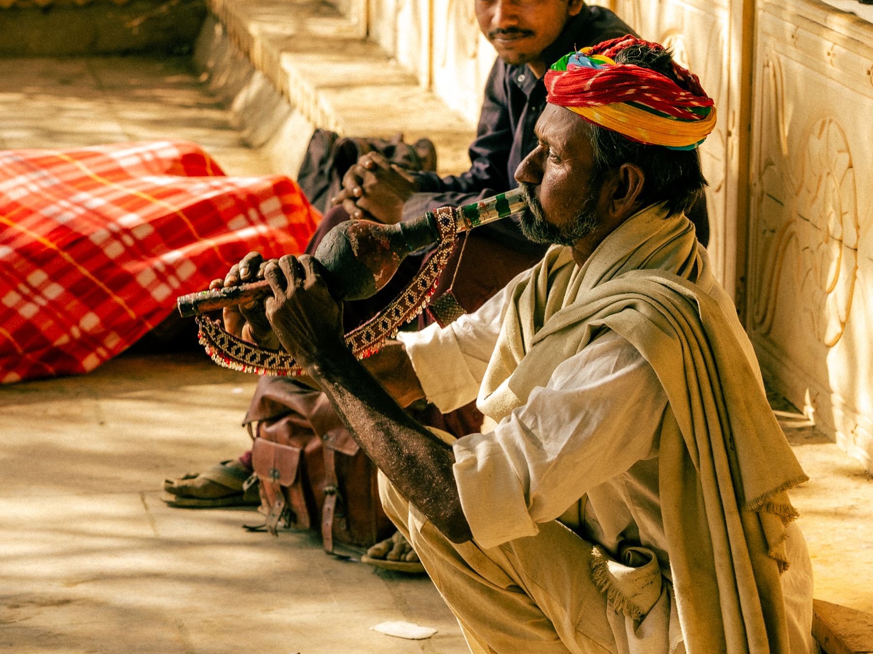 Seated Musician Playing Wind Instrument